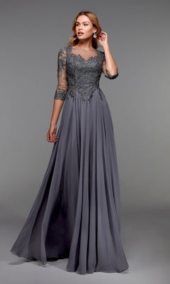 A woman models the Alyce 27474 long formal dress in stone, featuring a flowing chiffon A-line skirt, embellished bodice, and three-quarter sleeves, standing before a plain gray background.