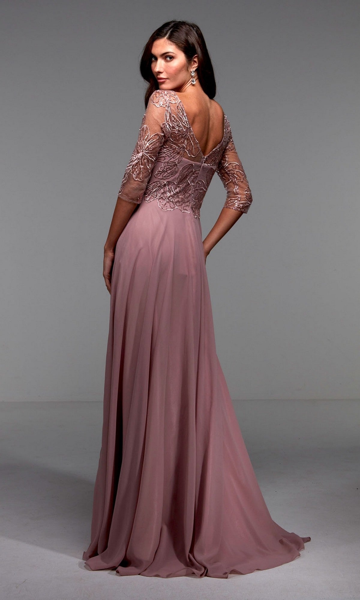 A woman models the Alyce 27475 long formal dress with a mauve lace bodice, sheer sleeves, and open back—a stunning mother-of-the-bride option.