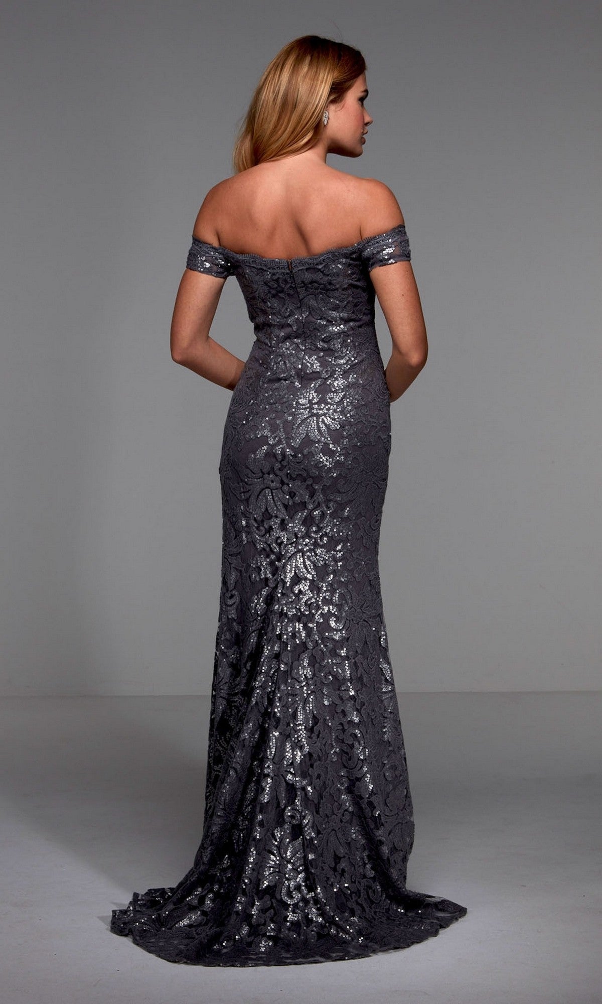 A woman models the Long Formal Dress: Alyce 27485—an off-the-shoulder evening gown in dark silver lace, seen from the back against a plain background. A sophisticated choice for a mother of the bride.