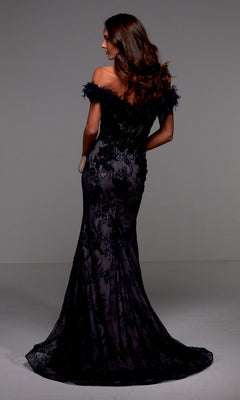 A woman faces away from the camera, wearing the Alyce 27490 long formal dress with lace detailing, an off-the-shoulder neckline, a fitted mermaid silhouette, and a dramatic floor-length train.