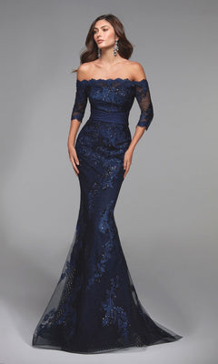 A woman poses against a plain gray backdrop in the Alyce 27495 long formal dress—a navy, off-the-shoulder, floor-length mermaid gown with beaded lace and sequin details, ideal for a mother-of-the-bride look.