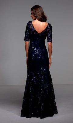 Model in Alyce 27497—a dark blue, floor-length formal dress with shimmering sequins, half sleeves, and a V-back—stands against a plain background. An elegant choice ideal for a mother-of-the-bride.