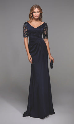 A woman in the Alyce 27498 long formal dress in midnight, featuring lace half sleeves and a ruched bodice, holds a small dark clutch while standing against a plain gray background.