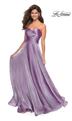 A woman wears the La Femme Strapless Long Prom Ball Gown 27515 in lilac, featuring a ruched fitted sweetheart bodice and flowing A-line skirt. The La Femme logo is shown in the top right corner.