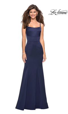 Woman in a navy La Femme Square-Neck Simple Long Prom Dress 27524 with thin straps and mermaid skirt, smiling against a white background. "La Femme" logo appears in the top right corner.
