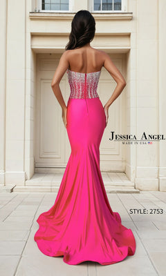 A woman stands with her back to the camera in front of a building entrance, wearing the Jessica Angel 2753 Long Prom Dress— a pink strapless mermaid gown with crystal-embellished corset. Text: "Jessica Angel" and "Style: 2753.