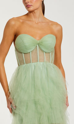 Woman wearing the Strapless Ruffled Long Prom Dress: Mac Duggal 27532 in mint green tulle, featuring a sheer corset-style bodice and layered ruffled skirt—the ideal choice for an unforgettable prom night.