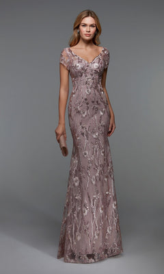 A woman in the Alyce 27533 long formal dress in rosewood, featuring short sleeves, floral embellishments, and a sheath silhouette, holds a matching clutch against a plain gray background.
