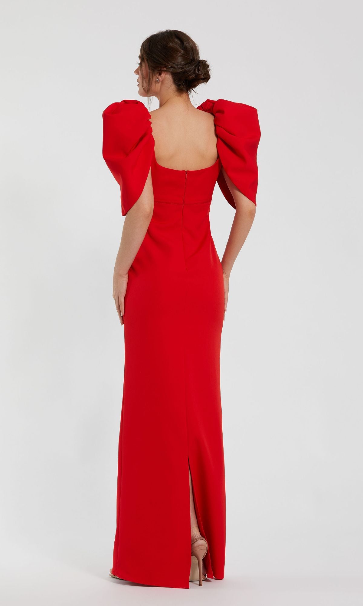 Woman wearing the Mac Duggal 27534 Puff-Sleeve Long Formal Dress, a fitted red evening gown with puffed sleeves, seen from behind against a plain white background.