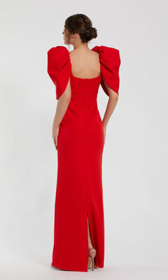Woman wearing the Mac Duggal 27534 Puff-Sleeve Long Formal Dress, a fitted red evening gown with puffed sleeves, seen from behind against a plain white background.