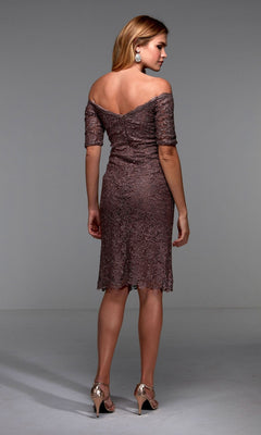 A woman models the Alyce 27535, a knee-length semi-formal dress featuring an off-the-shoulder lace design in muted mauve, as she faces away to showcase the elegant back details paired with metallic heels.