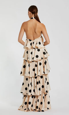 Back view of a cream, floor-length Mac Duggal 27540 halter dress with large black polka dots and a ruffle tiered silhouette.