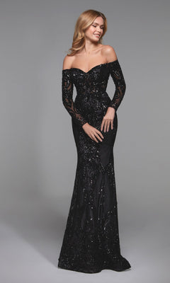 A woman poses against a plain gray background wearing the black Alyce 27544, a long formal dress featuring off-the-shoulder long sleeves, sequin detailing, a fitted bodice, and a floor-length skirt.