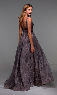 A woman wearing the Alyce 27552 long formal dress, featuring lace, a sleeveless design, and a deep V-back, stands facing away while looking over her shoulder.