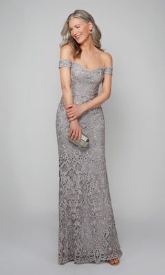A woman in the Alyce 27553 long silver formal dress, featuring off-the-shoulder beaded lace, holds a small clutch and smiles against a plain light gray background.