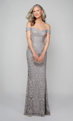 A woman in the Alyce 27553 long formal dress, featuring off-the-shoulder beaded lace, stands holding a small clutch against a plain light background.