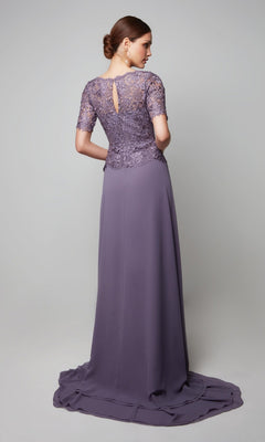 Mother-of-the-bride in the Alyce 27556 long formal dress—mauve, floor-length, with a beaded lace bodice and short sleeves—stands facing away, hair styled in a low bun.