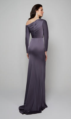 Woman wearing the Alyce 27557, a long, fitted dark purple formal dress with long sleeves and ruched back detail, standing against a light gray background. An elegant choice for a stylish wedding guest look.