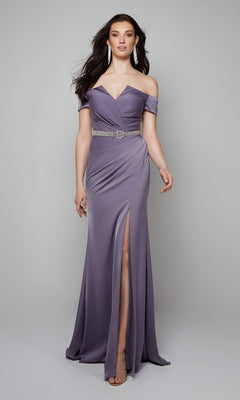 A woman models the Alyce 27558 long formal dress in lavender, featuring an off-the-shoulder neckline, thigh-high slit, and decorative belt, posing elegantly against a plain light background.