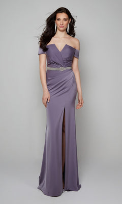 A woman models the Alyce 27558 long formal dress—an off-the-shoulder lavender gown with a thigh-high slit and silver belt—showcasing chic mother of the bride style against a plain light gray background.