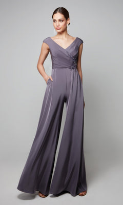 A woman models the Alyce 27559 Long Formal Jumpsuit—a sleeveless, wide-leg mauve piece with a V-neckline and floral bodice details—perfect for wedding guests, set against a plain background.