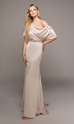 A woman models the Alyce 27560 long formal dress—an off-the-shoulder, light beige satin gown with a draped neckline and side slit—standing before a plain gray background.