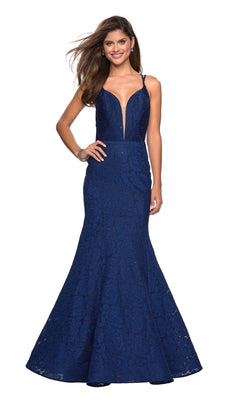 A woman wears the La Femme 27560 Backless Lace Mermaid Prom Dress featuring a sleeveless, deep V-neck fitted bodice and floor-length navy blue mermaid-style skirt.