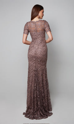 A woman stands with her back to the camera in the Alyce 27561 long formal dress—a floor-length, short-sleeved, fitted lace gown in muted brown, ideal as an elegant mother-of-the-bride option.