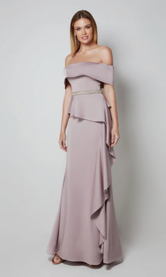A woman poses against a plain background in the Alyce 27563 long formal dress, an off-the-shoulder mauve gown with ruffle details and a beaded belt—an elegant option for a mother-of-the-bride.