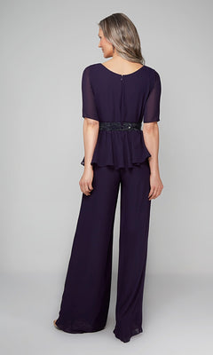 Woman stands with her back to the camera, wearing the Alyce 27576 Long Formal Jumpsuit—dark purple with wide-leg pants, a peplum top, and beaded waistband—set against a plain light gray background.