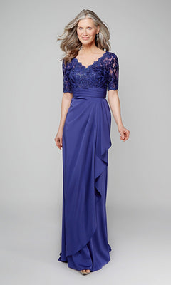 A woman models the Alyce 27595 long formal dress—a royal blue, floor-length mother-of-the-bride gown featuring a lace bodice and short sleeves—against a plain light gray background.
