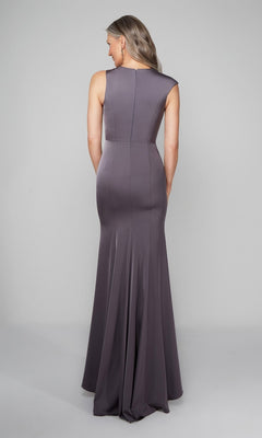 A woman faces away, wearing the Alyce 27598 long formal dress—a sleeveless, floor-length column gown in purple-gray with a slight bottom flare—set against a plain light background.