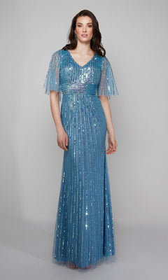 A woman poses against a plain gray background wearing the Alyce 27599 long formal dress, featuring blue beaded sequins, a floor-length silhouette, short sheer sleeves, and a V-neck.