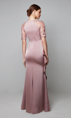 A woman faces away, wearing the Alyce 27601 long formal dress in mauve featuring a fitted floor-length silhouette, short embroidered lace sleeves, and a side ruffle detail.