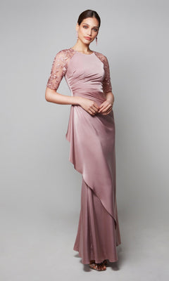 A woman wears the Alyce 27601 long formal dress in mauve, featuring draped fabric and short sheer floral-embroidered sleeves; perfect as a mother-of-the-bride gown, shown against a neutral background.
