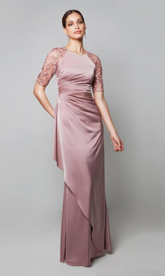 A woman models the Alyce 27601 long formal dress in mauve, featuring short sheer embroidered sleeves, against a plain light gray background—an ideal choice for an elegant mother-of-the-bride ensemble.
