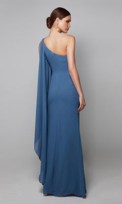 A woman faces away, wearing the Alyce 27603 long formal one-shoulder blue chiffon dress with draped fabric and gold earrings—an elegant mother-of-the-bride choice—set against a plain gray background.