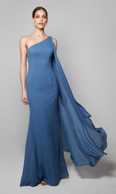 A woman wears the Alyce 27603 long formal dress—a floor-length, one-shoulder chiffon gown with a flowing drape—standing against a plain light gray background, perfect for mothers of the bride or any formal event.