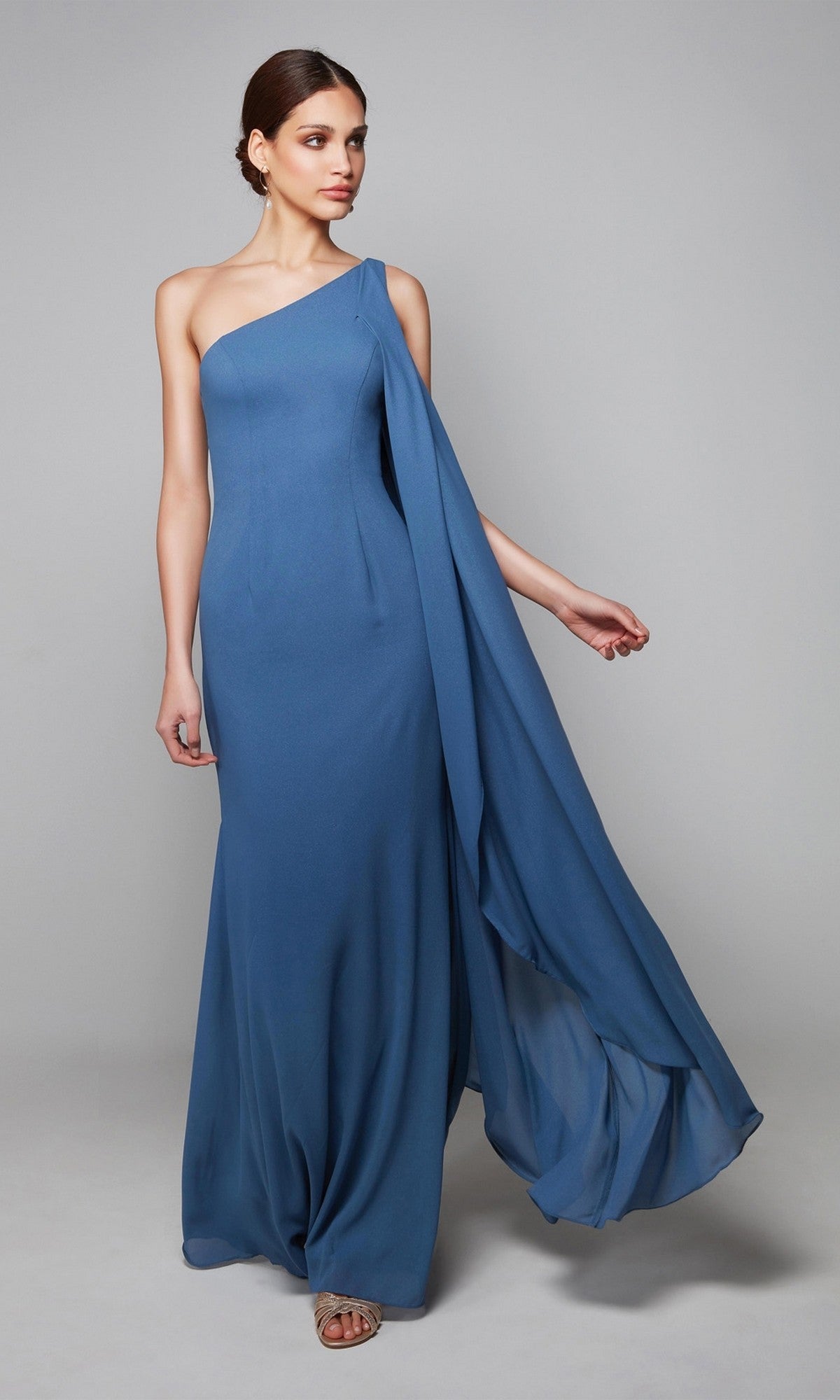 A woman models the Alyce 27603, a floor-length, one-shoulder chiffon dress with a draped sleeve, perfect as a mother-of-the-bride formal gown, against a plain light gray background.