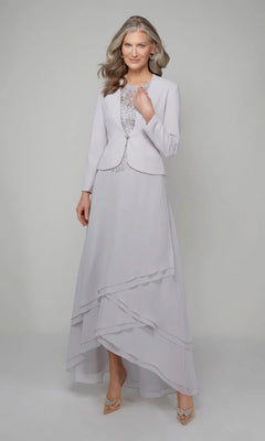 A woman with long gray hair wears the Alyce 27608 long formal dress in Sterling, featuring a beaded lace bodice, matching jacket, and layered skirt, standing against a plain light background.