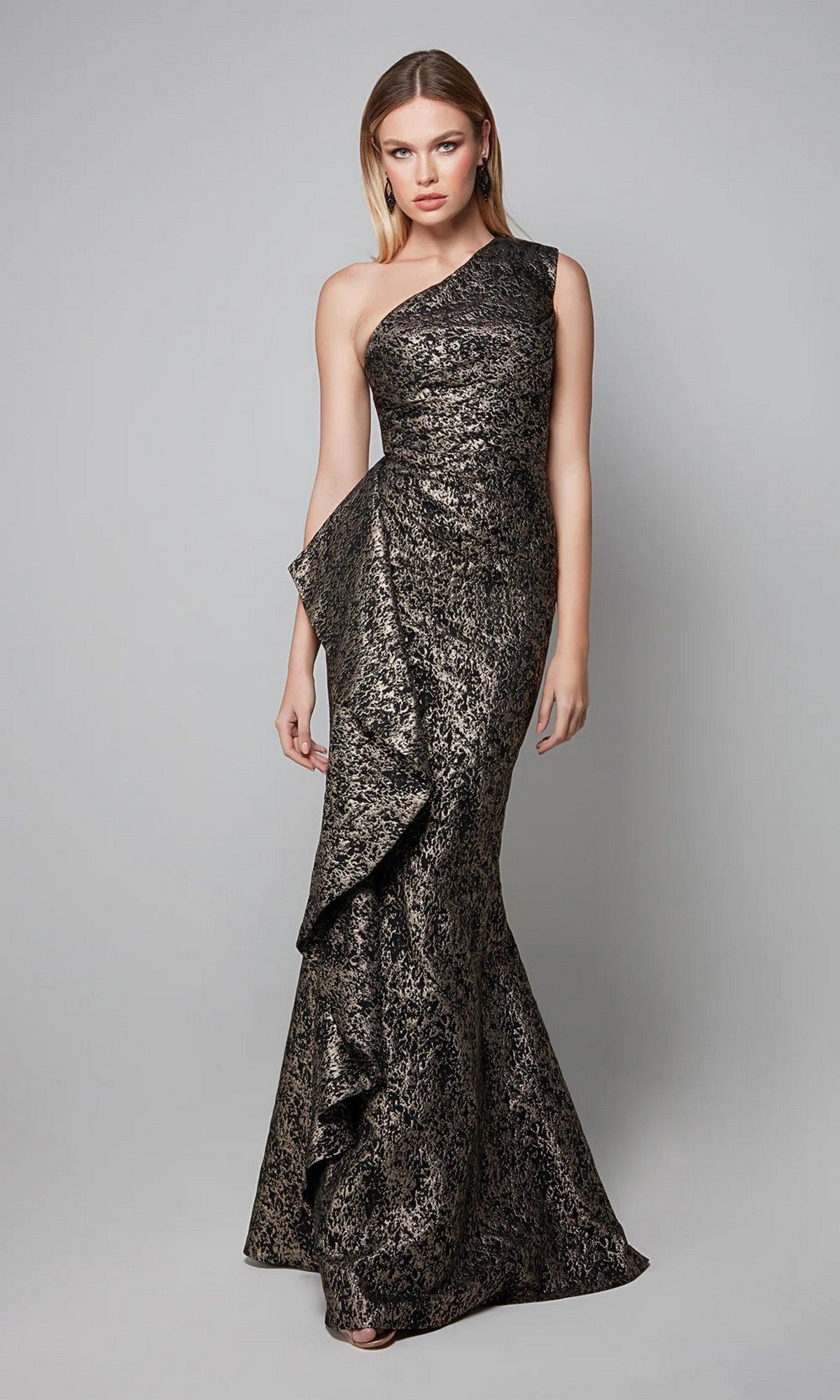 A woman models the Alyce 27620—an elegant, metallic one-shoulder long formal dress with textured jacquard and ruffle detail—perfect for any mother-of-the-bride, shown against a plain gray background.