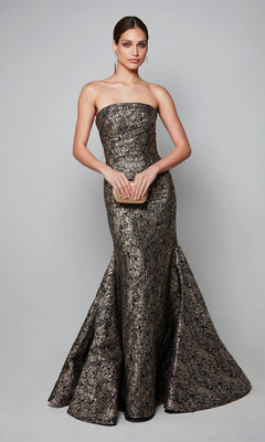 Woman wearing the Alyce 27621 Long Formal Dress, a strapless jacquard gown with a mermaid silhouette, holds a small clutch against a plain gray background for an elegant formal evening look.