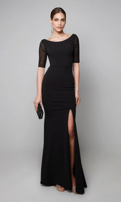 A woman wears the Alyce 27628 long black formal jersey dress featuring a thigh-high slit and lace half-sleeves, accessorized with a black clutch and strappy heels, standing against a plain background.