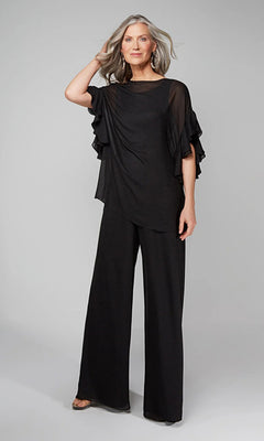 A woman models the Long Formal Jumpsuit: Alyce 27633 in black, featuring a loose top with sheer ruffled sleeves and matching wide-leg pants, posed against a light grey background.