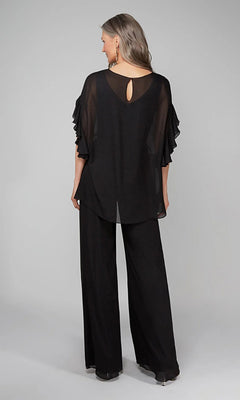 A woman faces away in the Long Formal Jumpsuit: Alyce 27633, featuring sheer ruffled sleeves and black wide-leg pants, set against a plain light gray background.