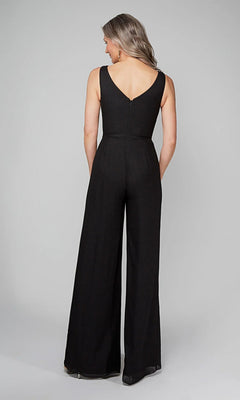 A woman with long hair stands with her back to the camera, wearing the Alyce 27633 Long Formal Jumpsuit—a chic black wide-leg style—against a plain background.