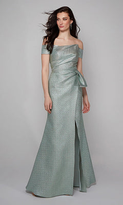 A woman wears the Alyce 27639 Long Formal Dress in Dripping Diamonds (Silver), featuring an off-the-shoulder design, fitted bodice, side bow detail, and floor-length skirt against a plain background.