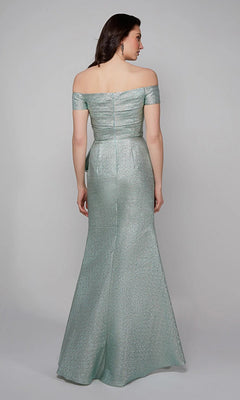 A woman faces away, wearing the Alyce 27639 long formal dress—a shimmering light green, off-the-shoulder gown with a fitted bodice and floor-length skirt.
