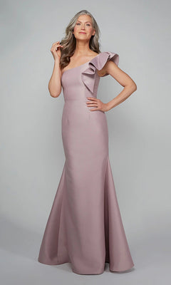 Woman modeling the Alyce 27641 long formal dress in smoke color, featuring Mikado fabric and a one-shoulder design with a large ruffle, posed against a plain gray background.