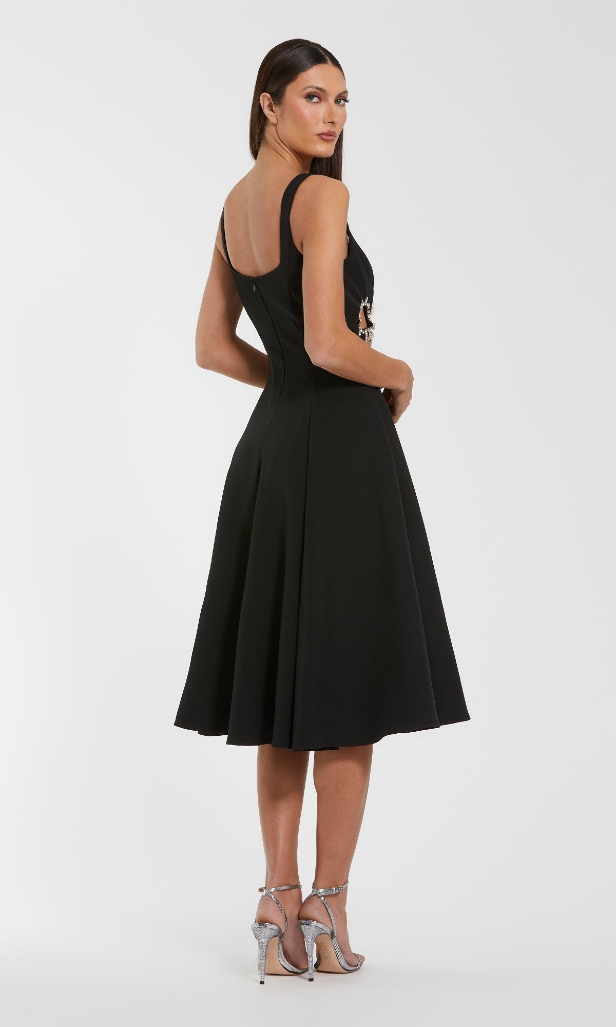 Woman wearing a black dress on a white background